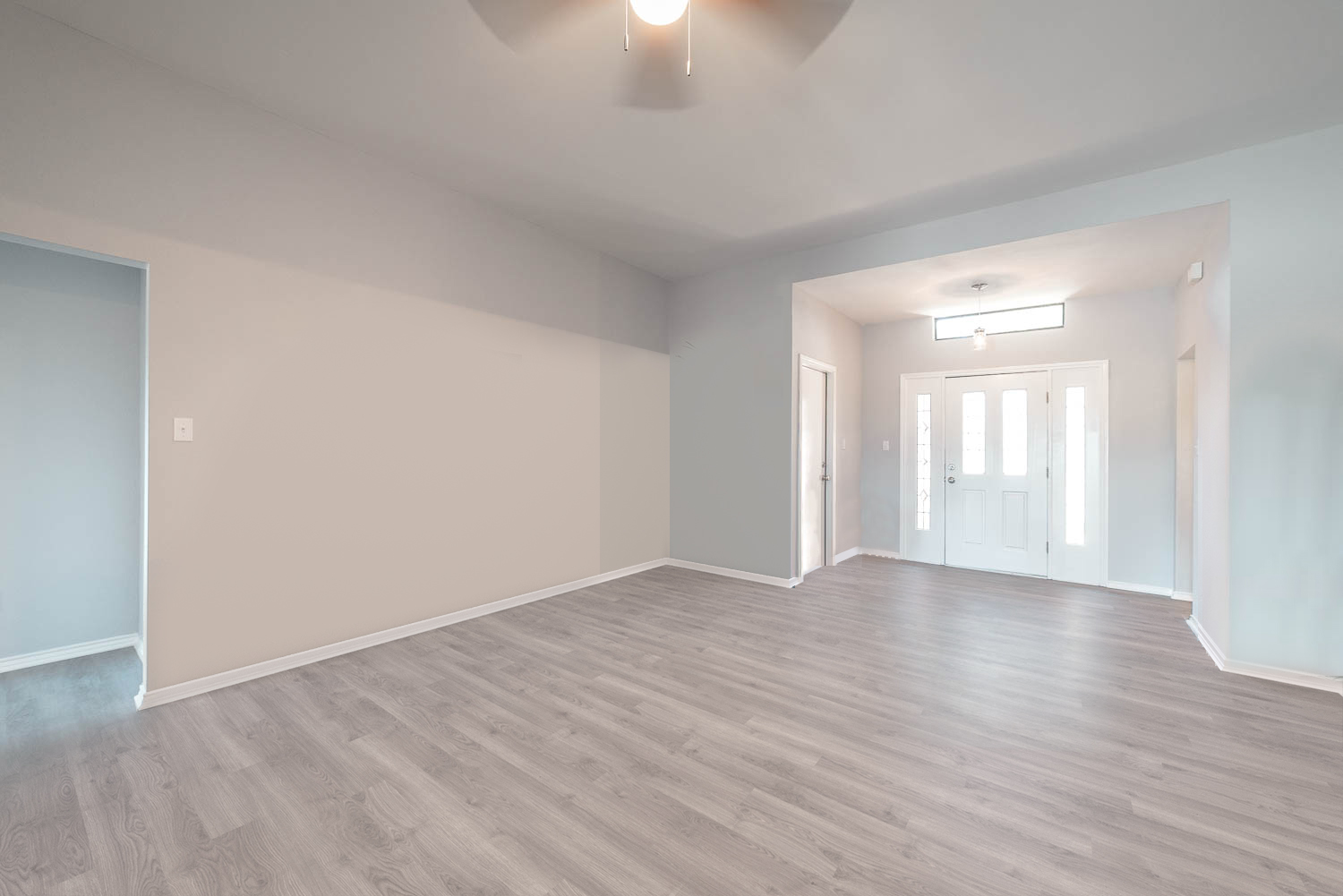 A room with hard wood floors and white walls.