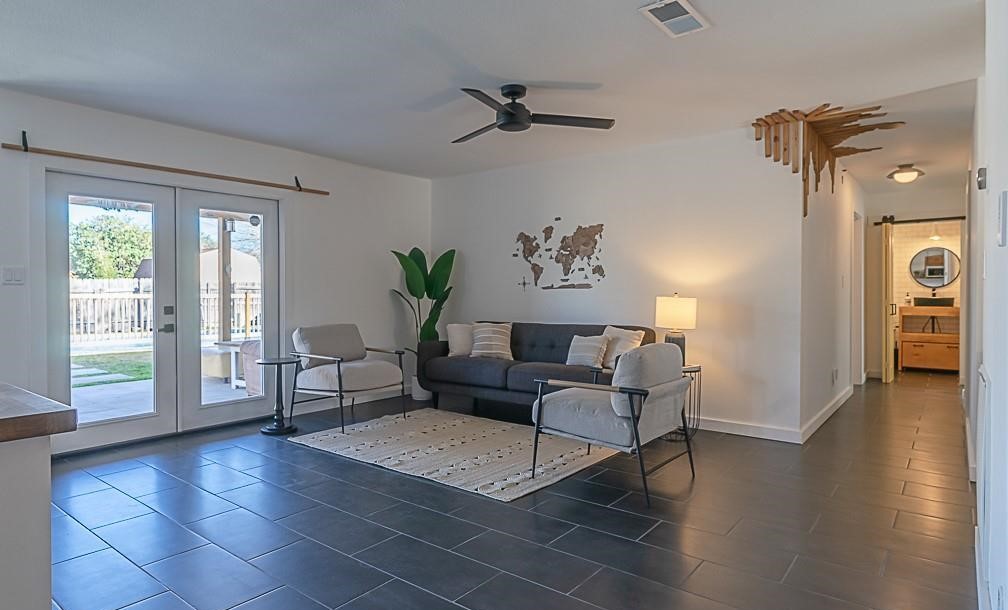 A living room with two chairs and a couch